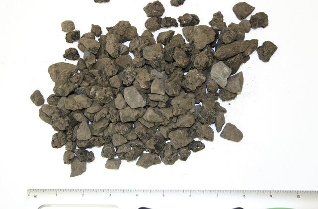 Aggregate rock material sample for concrete and site preparation.